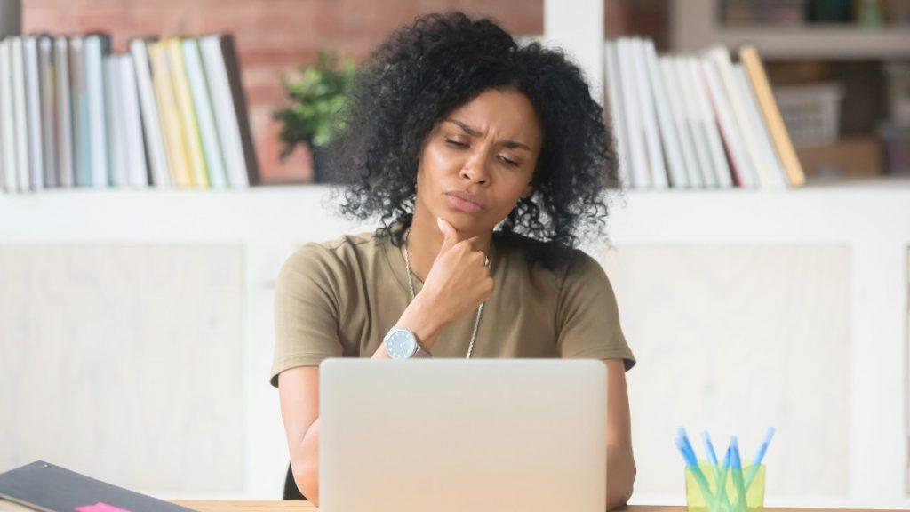 person sitting at a laptop, making decisions